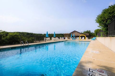 Enjoy sunny days at the community pool with lounge chairs and panoramic views of the Ozark hills.