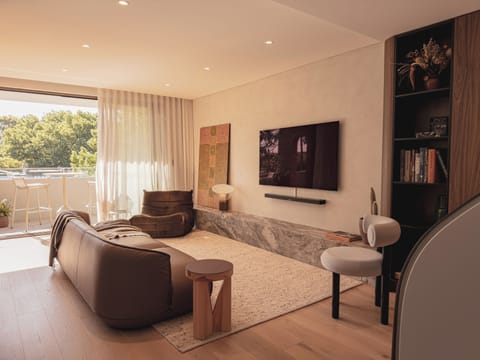Spacious living room with designer furniture &  a TV for your convenience.