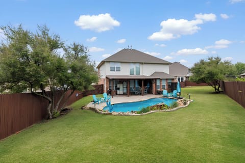 Fenced backyard - private pool, waterfall feature, shaded patio seating, & grill