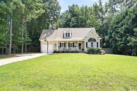 Charming home with spacious lawn and peaceful wooded surroundings