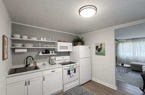 Bright kitchen with open shelving and full-size appliances