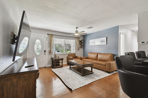 Step into a bright and welcoming living room where comfort meets style. Relax on the leather sofa, enjoy your favorite shows on the large TV, or unwind in this inviting space designed for cozy gatherings.