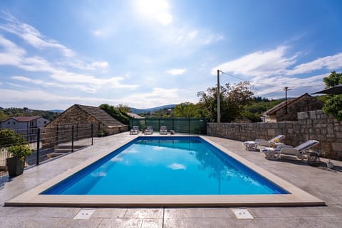 The expansive sun deck surrounds the sparkling 50sqm private swimming pool, providing an ideal spot for relaxation and sunbathing.