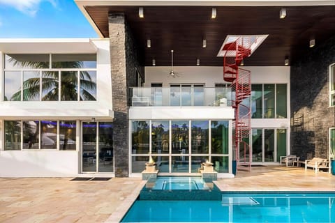 Modern luxury home unique spiral staircase pool area family fun.