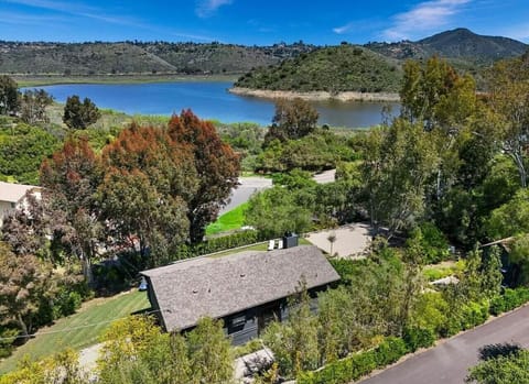 Aerial view showcasing the home`s prime location just steps from Lake Hodges, offering breathtaking lake views and easy access to outdoor activities.