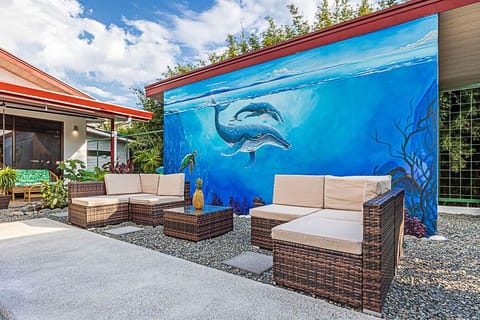 Families and couples will love this cozy outdoor lounge with comfortable seating and a unique whale mural centerpiece.