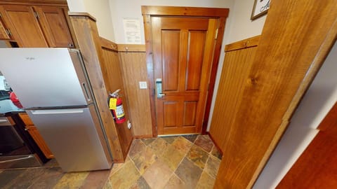 Cozy entryway with rustic wood accents and stone flooring