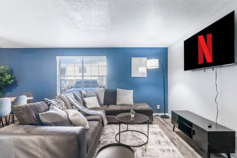 Spacious and inviting living area with comfortable seating and a smart TV, perfect for relaxing after exploring Arlington or attending events at AT&T Stadium.