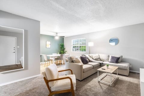 Spacious and inviting living area with comfortable seating and a smart TV, perfect for relaxing after exploring Arlington or attending events at AT&T Stadium.