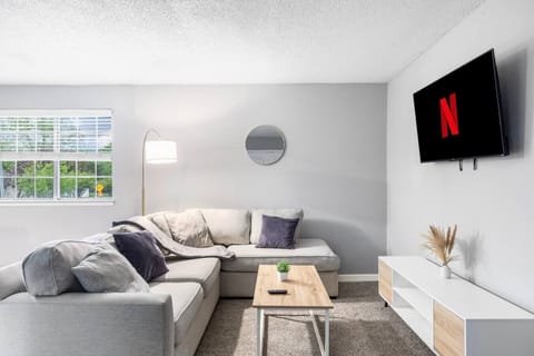 Spacious and inviting living area with comfortable seating and a smart TV, perfect for relaxing after exploring Arlington or attending events at AT&T Stadium.