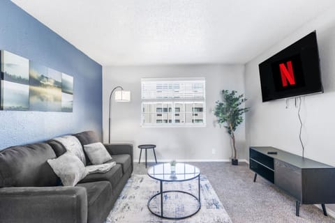 Spacious and inviting living area with comfortable seating and a smart TV, perfect for relaxing after exploring Arlington or attending events at AT&T Stadium.