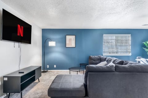 Spacious and inviting living area with comfortable seating and a smart TV, perfect for relaxing after exploring Arlington or attending events at AT&T Stadium.