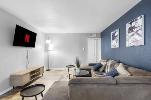 Spacious and inviting living area with comfortable seating and a smart TV, perfect for relaxing after exploring Arlington or attending events at AT&T Stadium.