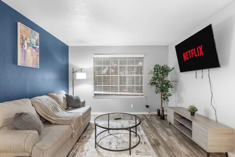 Spacious and inviting living area with comfortable seating and a smart TV, perfect for relaxing after exploring Arlington or attending events at AT&T Stadium.