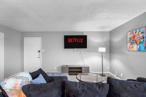 Spacious and inviting living area with comfortable seating and a smart TV, perfect for relaxing after exploring Arlington or attending events at AT&T Stadium.