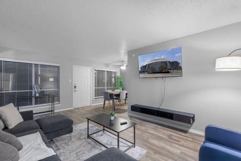 Spacious and inviting living area with comfortable seating and a smart TV, perfect for relaxing after exploring Arlington or attending events at AT&T Stadium.