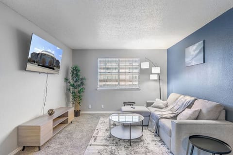 Spacious and inviting living area with comfortable seating and a smart TV, perfect for relaxing after exploring Arlington or attending events at AT&T Stadium.