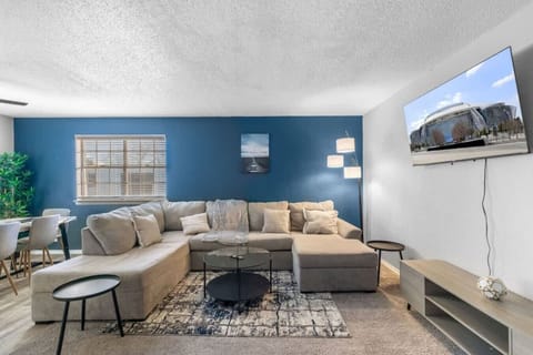 Spacious and inviting living area with comfortable seating and a smart TV, perfect for relaxing after exploring Arlington or attending events at AT&T Stadium.