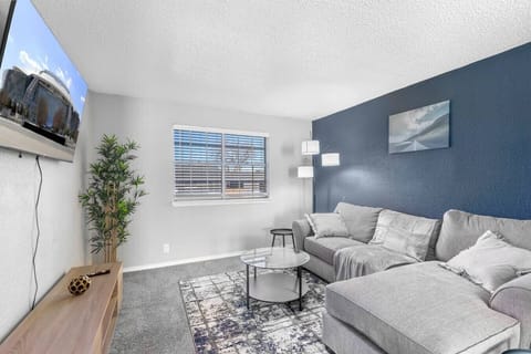 Spacious and inviting living area with comfortable seating and a smart TV, perfect for relaxing after exploring Arlington or attending events at AT&T Stadium.