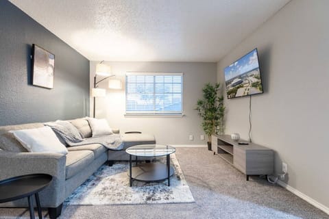 Spacious and inviting living area with comfortable seating and a smart TV, perfect for relaxing after exploring Arlington or attending events at AT&T Stadium.