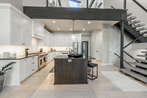 Fully stocked kitchen with gas stove, full fridge, and everything you need to cook at home.