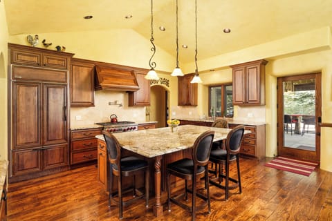 Gorgeous chef's kitchen with ample space. Gas range, built in fridge, and room to spread out and cook.