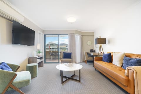 Bright and inviting living area styled with warm tones and comfy seating. Perfect for relaxing