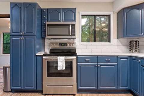 Microwave, stove and oven with counter prep space. 