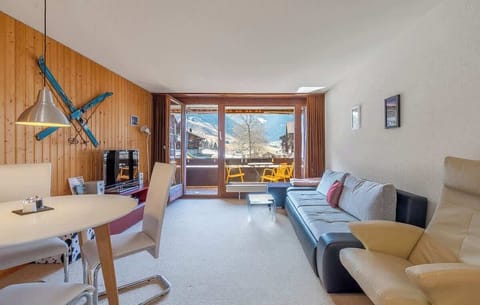 Spacious and light-filled living area with direct access to the balcony and beautiful alpine views.
