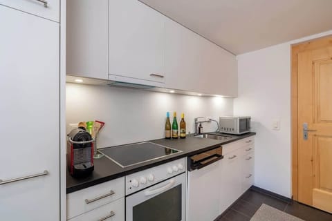 Sleek kitchenette with appliances and storage…