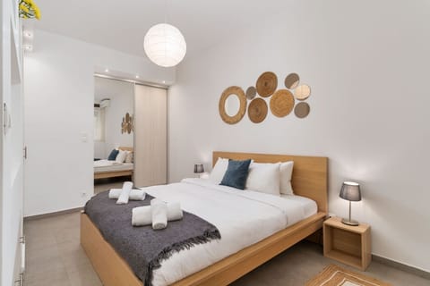 Serene queen-size bedroom with warm tones, soft lighting, and handcrafted wall decor.