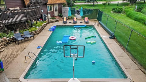 Our fenced in backyard  area has a hot tub, heated pool, lounge furniture, dining set, gas grill, pool furniture, and pool toys.
