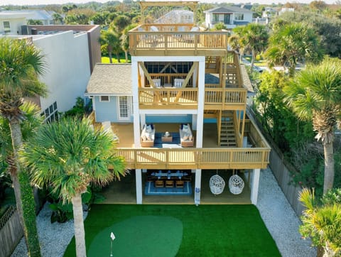 Three levels of coastal living — rooftop views, shaded balconies, and a private putting green below. 🌴✨