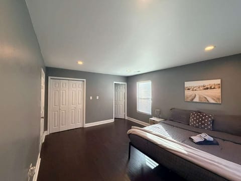 A peaceful bedroom featuring soft linens, blackout curtains, and a cozy retreat after a long day exploring Charlotte.