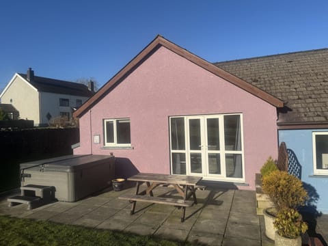 Outside of cottage with hot tub