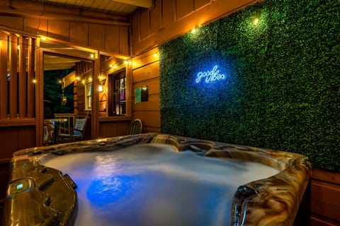 Private hot tub with neon vibes on a cozy covered deck