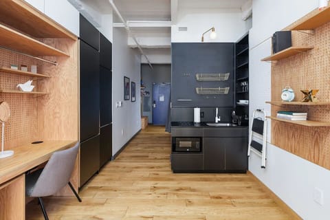 Cook easy meals in the sleek kitchenette with modern finishes.