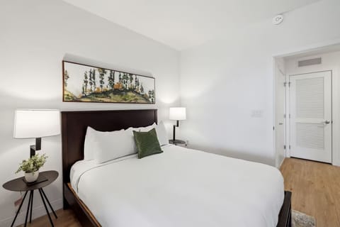 Sink into crisp linens under soft, warm bedside light.