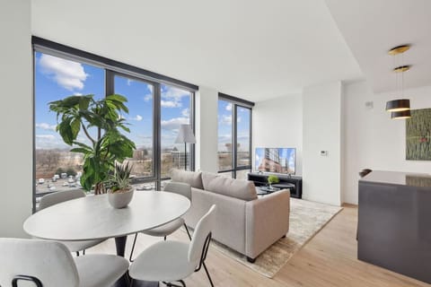 Gather for meals beside panoramic windows and leafy indoor greenery.
