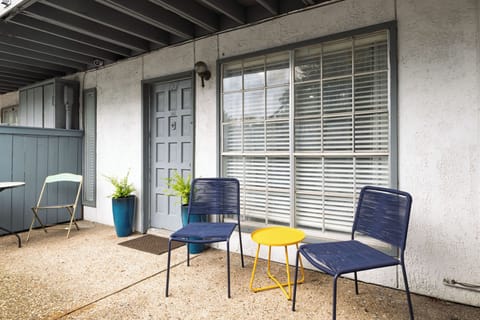 Step outside to a private patio with casual seating - an inviting spot to relax.
