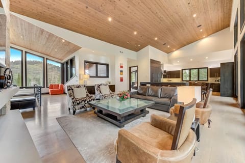 Soaring ceilings, forest views, and a stone fireplace set the tone for mountain comfort.