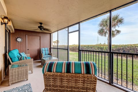 Screened-in patio with seating- perfect for watching morning sunrises
