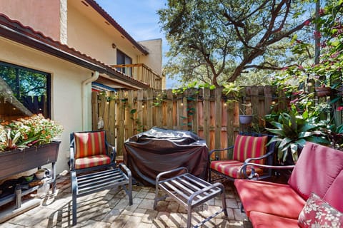 Tropical backyard w/ Fenced, BBQ grill, and outdoor seating