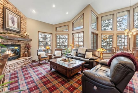 Living room (main floor): Gas fireplace, Smart TV, balcony access, radiant heat