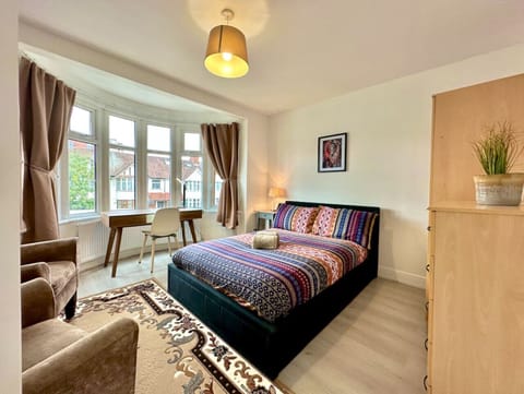 Cosy bedroom space with seating and plenty of light