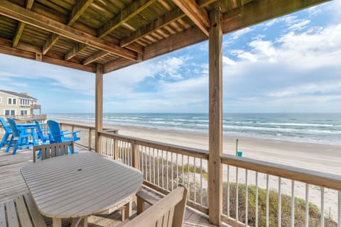 Sip your morning coffee on this oceanfront deck with stunning beach views and gentle waves at your doorstep.