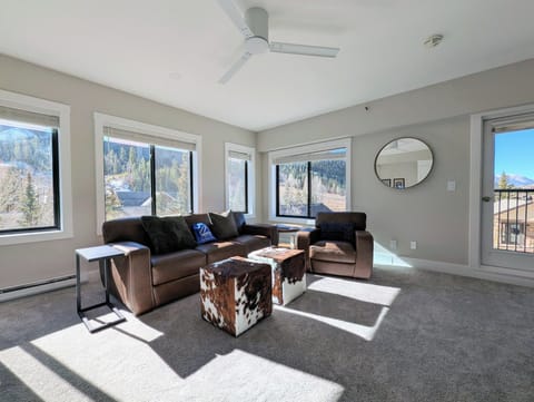 Bright and modern living room with mountain views & rustic seating