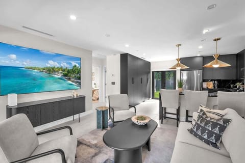Inviting living room seamlessly connected to the kitchen, with easy access to the backyard