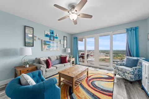 Relax in this bright living room with coastal decor and a balcony view.