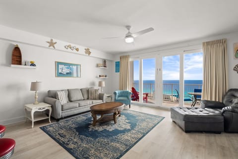 Relax in this bright living room with ocean views and coastal decor.